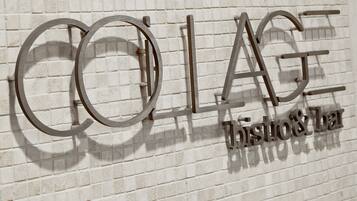 A wall with the word "COLAGE" and "bistro bar" in a modern font.