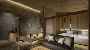 A modern hotel room with a sofa, a coffee table, a desk, and a bed. - Hatsuhana (Hakone)