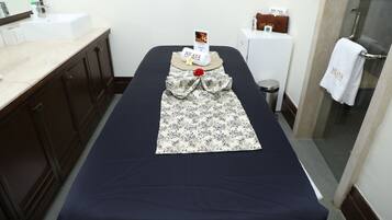 Relax in comfort with a neatly arranged bed area, featuring a plush bed and thoughtful touches.