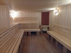 A sauna with wooden benches and a tiled floor. - Cross Health Center (Yerevan)
