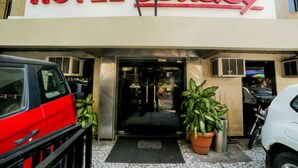 Een hotelentree met een bord waarop 'HOTEL Lucky' staat.