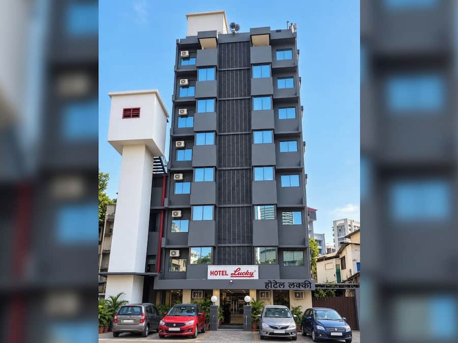 A modern hotel building with a sign reading 'HOTEL Lucky'.