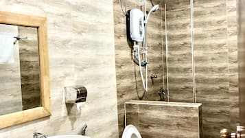A bathroom with a sink, toilet, and shower.