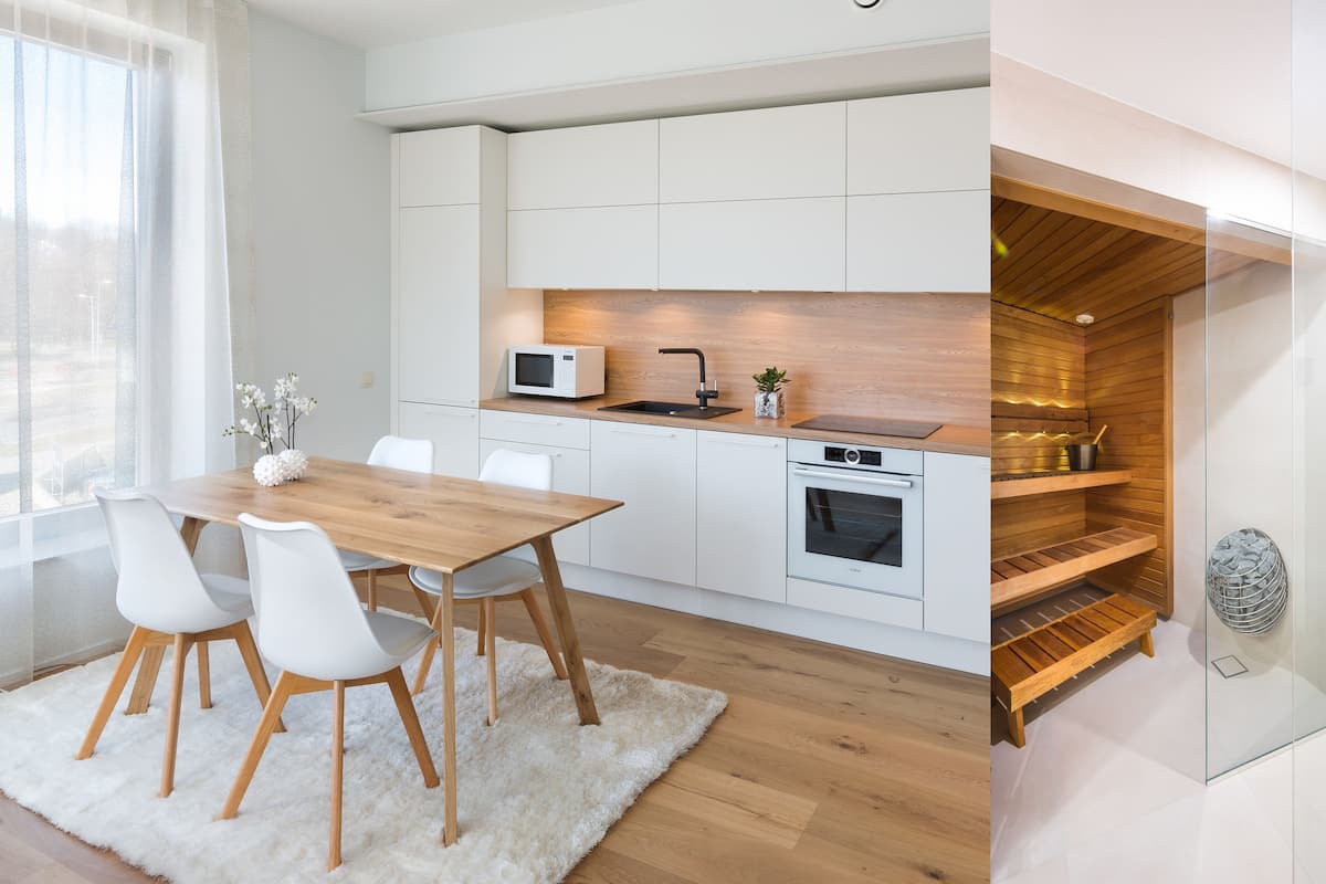 A modern kitchen with white cabinets, a wooden countertop, and a built-in oven.