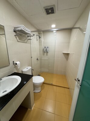 A small, modern bathroom with a sink, toilet, and shower. - Aeton Hotel (Nilai)
