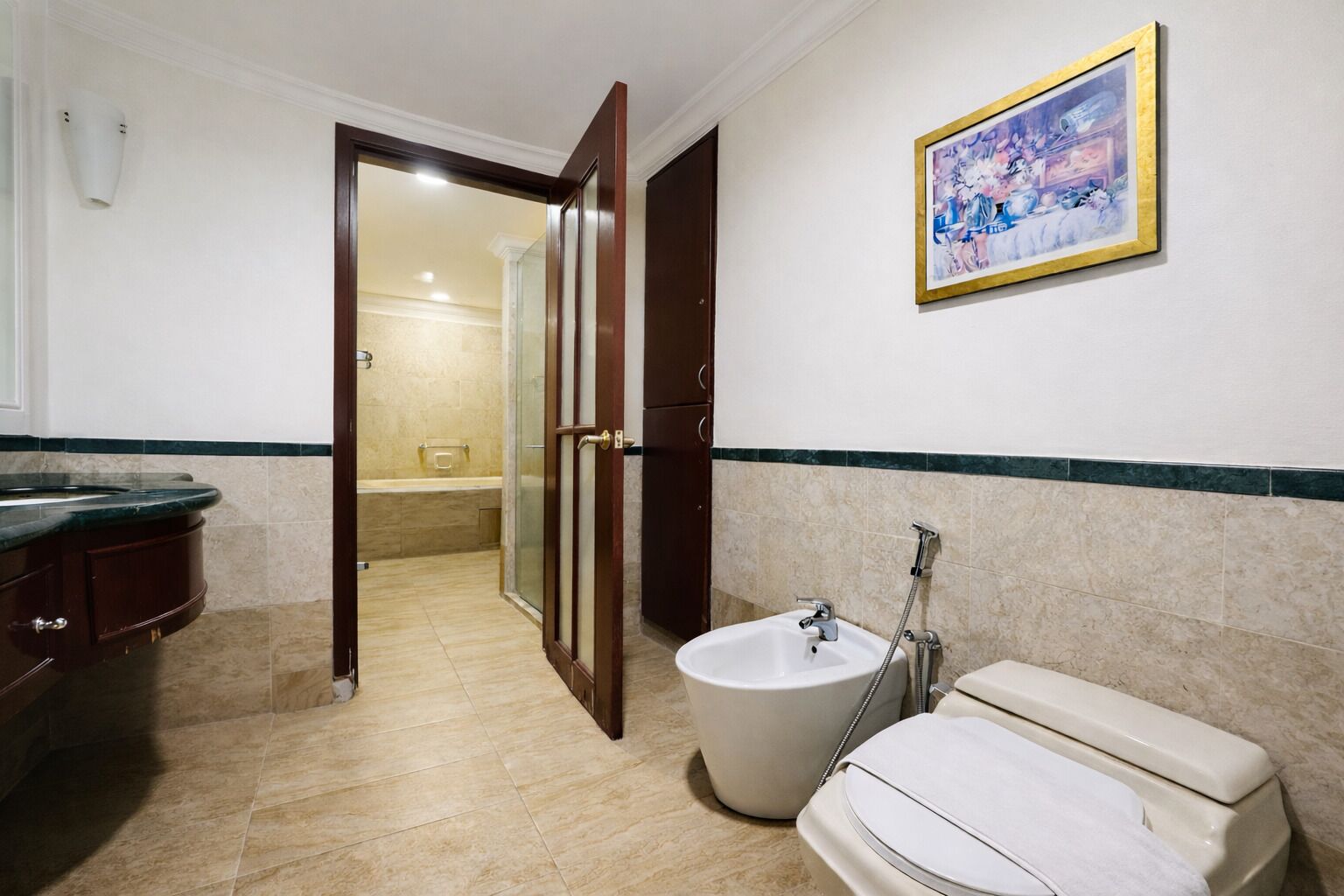 A bathroom with a bathtub, a toilet, a sink, and a shower.