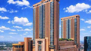 A high-rise building with multiple floors, a prominent entrance, and a clear view of the surrounding cityscape. - KL Bintang Suites at Times Square (Kuala Lumpur)