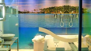 A bathroom with a large bathtub, a sink, and a mirror.