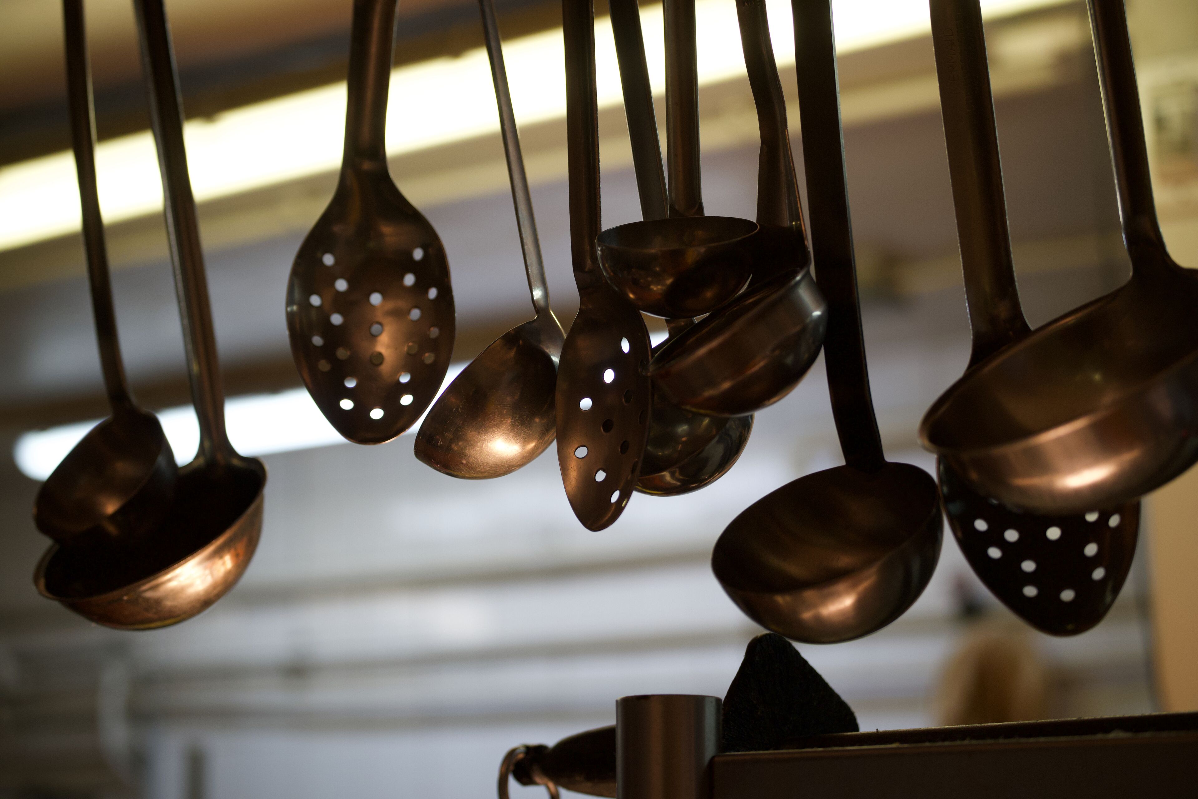 A collection of hanging kitchen utensils.