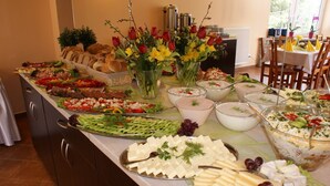 A buffet table with various food items, including cheese, fruits, and salads. - Dom Wczasowy Beskidy (Wisla)