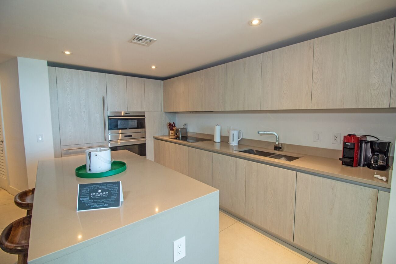 A modern kitchen with a central island, built-in appliances, and a minimalist design.
