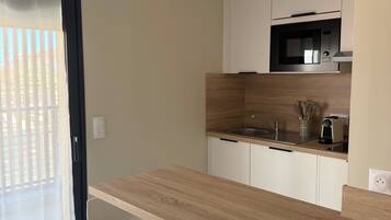 Standard Apartment | Living area | 32-inch flat-screen TV with digital channels, TV