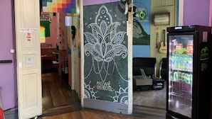 A room with a chalkboard wall, a refrigerator, and a guitar. - Massape Rio Hostel (Rio de Janeiro)
