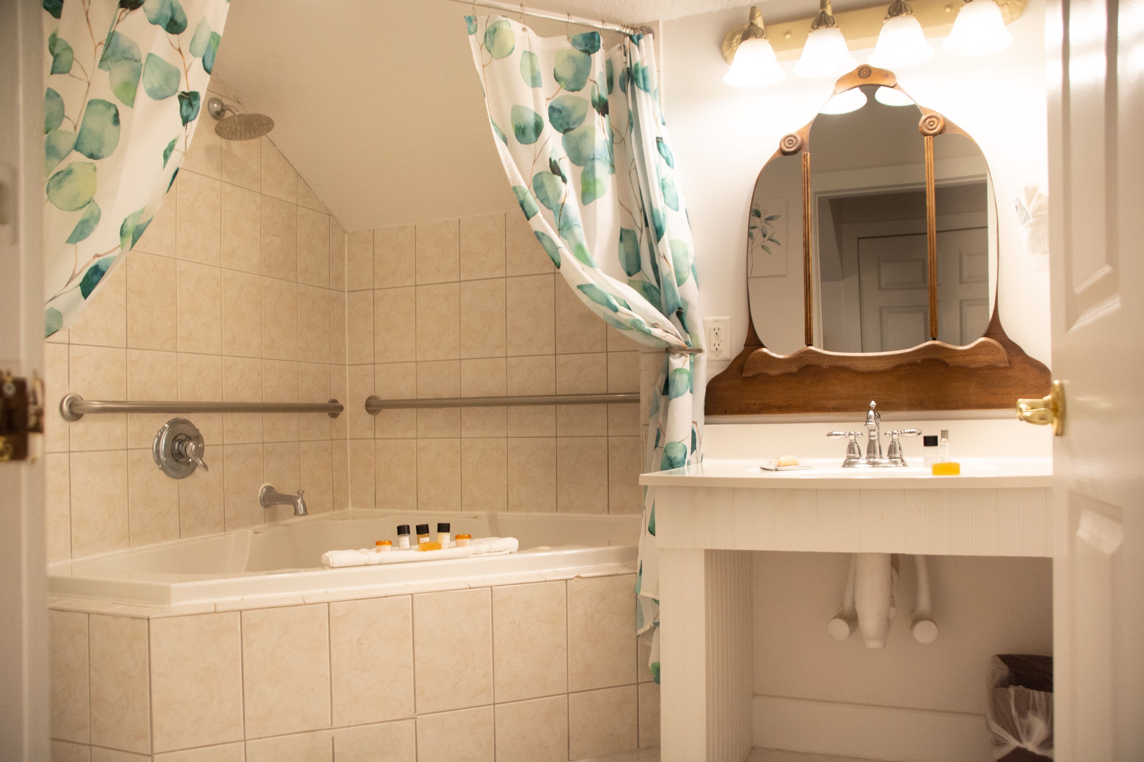 A bathroom with a bathtub, shower, and sink.