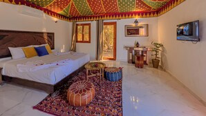 A hotel room with a bed, a small table, a TV, and a large window. - Villa Marco Marrakech (Tameslouht)