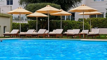 Seasonal outdoor pool, open 11:00 AM to 7:00 PM, pool umbrellas