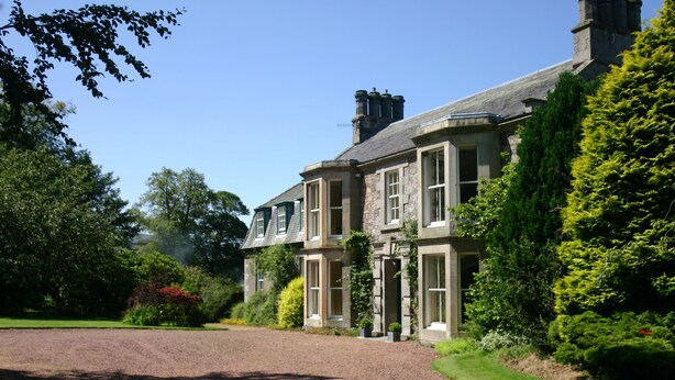 A large, historic stone building with multiple windows and a well-maintained garden. - Cormiston Farm (Biggar)
