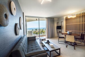 Premium Apartment, 1 Bedroom, Partial Sea View | Living area | 22-inch flat-screen TV with satellite channels, LCD TV