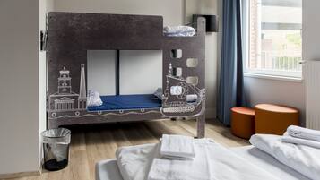Cozy retreat with a bunk bed featuring a decorative headboard, a single bed, and comfortable seating.