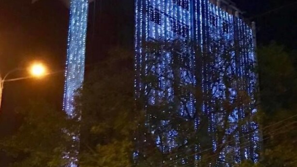 A building with the sign 'Hotel Lexus' at night, illuminated with blue lights. - Hotel Lexus Yangon (Yangon)