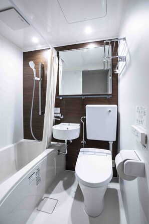 Bathroom features a white bathtub, sink, and toilet, complemented by dark wood paneling and a wall-mounted towel rack.
