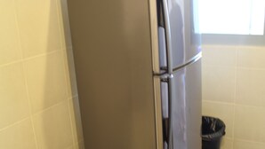 A stainless steel refrigerator in a kitchen with tiled walls and floor. - Peaceful Service Suites at Taragon Puteri Bintang (Kuala Lumpur)
