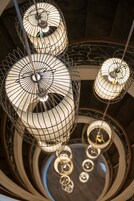 A spiral staircase with a modern design, featuring a series of circular platforms and a central column.
