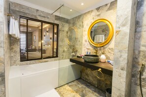A bathroom with a bathtub, a vanity with a large mirror, and a window with blinds. - Aliana Boutique Sapa Hotel & Spa (Sa Pa)