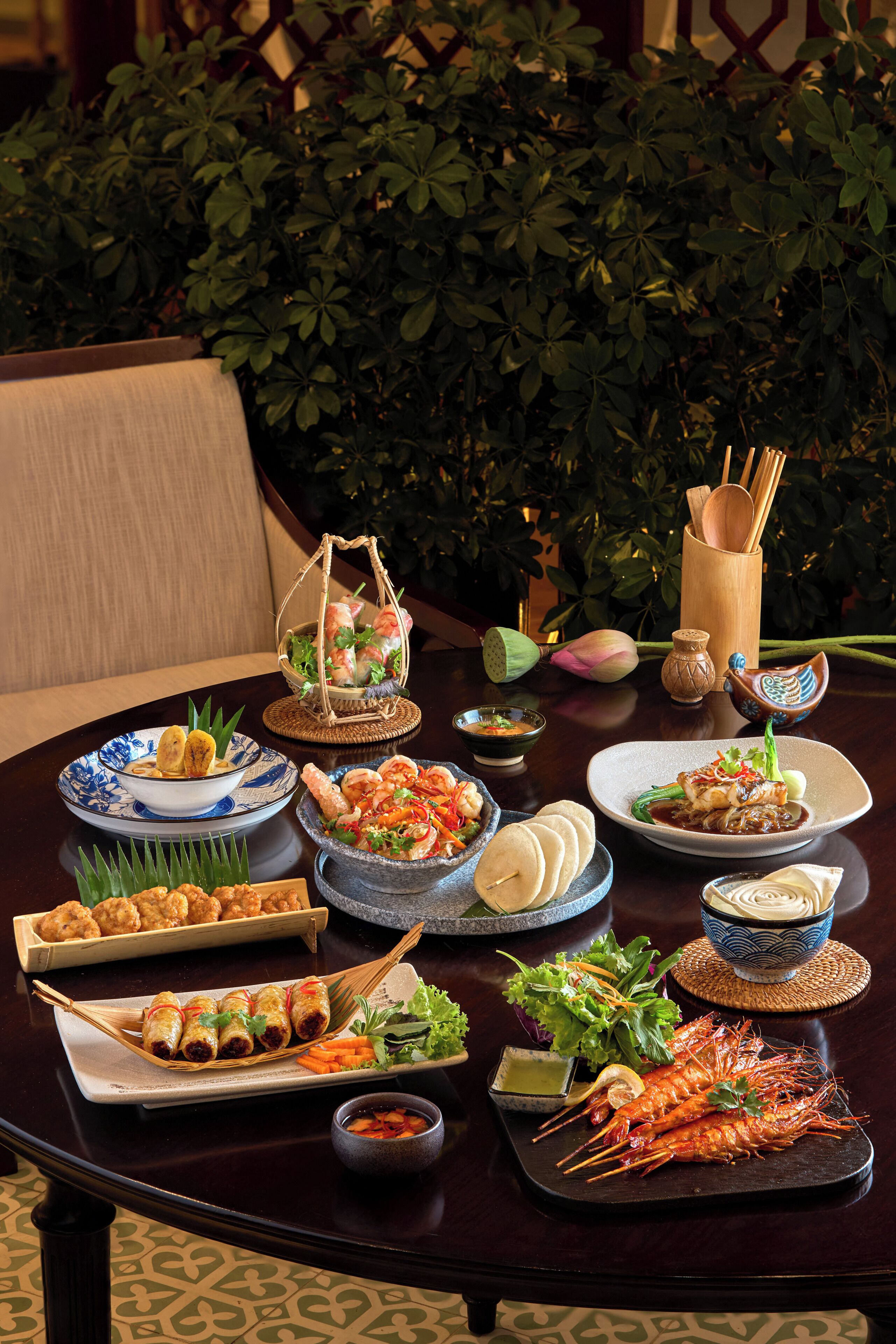 A table set with various dishes, including seafood, vegetables, and a dessert.