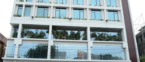 A multi-story building with a modern facade, large windows, and a prominent entrance.