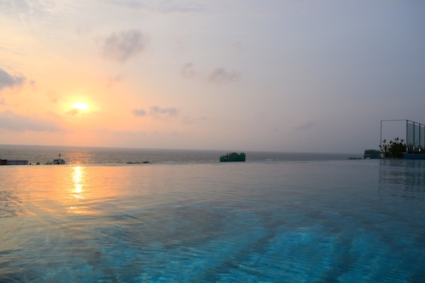Outdoor pool, open 7 AM to 7 PM, pool loungers