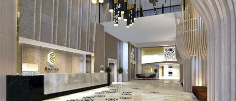 A modern hotel lobby with a reception desk, patterned floor, and contemporary lighting fixtures.