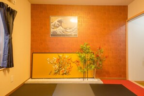 Experience serene tranquility in a room with a tatami mat floor, shoji screen, and minimalist design.