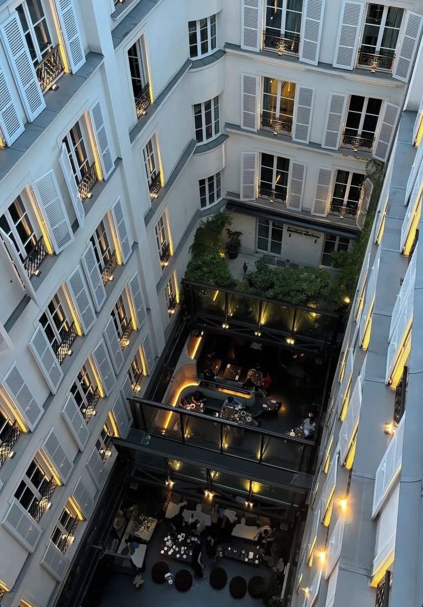 A multi-level courtyard with outdoor seating and a restaurant.