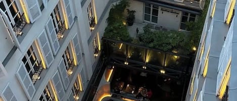 A multi-level courtyard with outdoor seating and a restaurant.