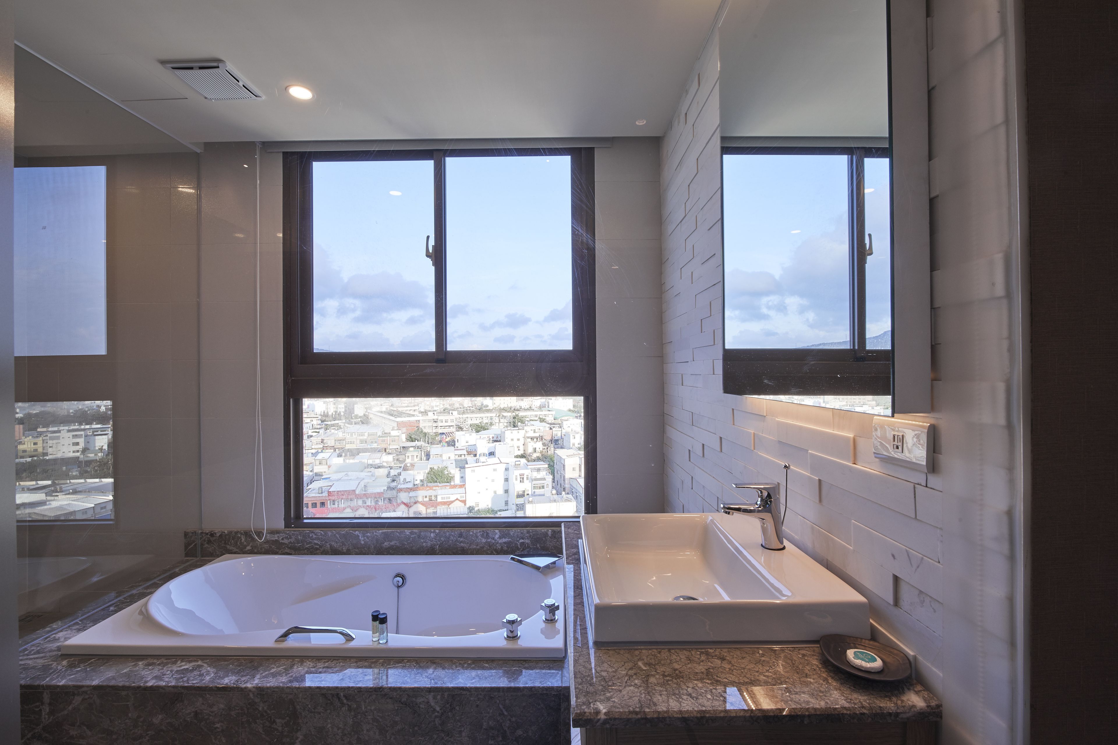 deluxe honeymoon suite | bathroom | separate bathtub and shower, hair dryer, towels