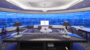 A modern hotel lobby with a panoramic city view, a reception desk, seating area, and exercise equipment. - Grand Bay Resort (Hengchun)