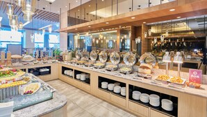 A buffet area with various food stations, including a salad bar, hot food, and a beverage station. - Grand Bay Resort (Hengchun)