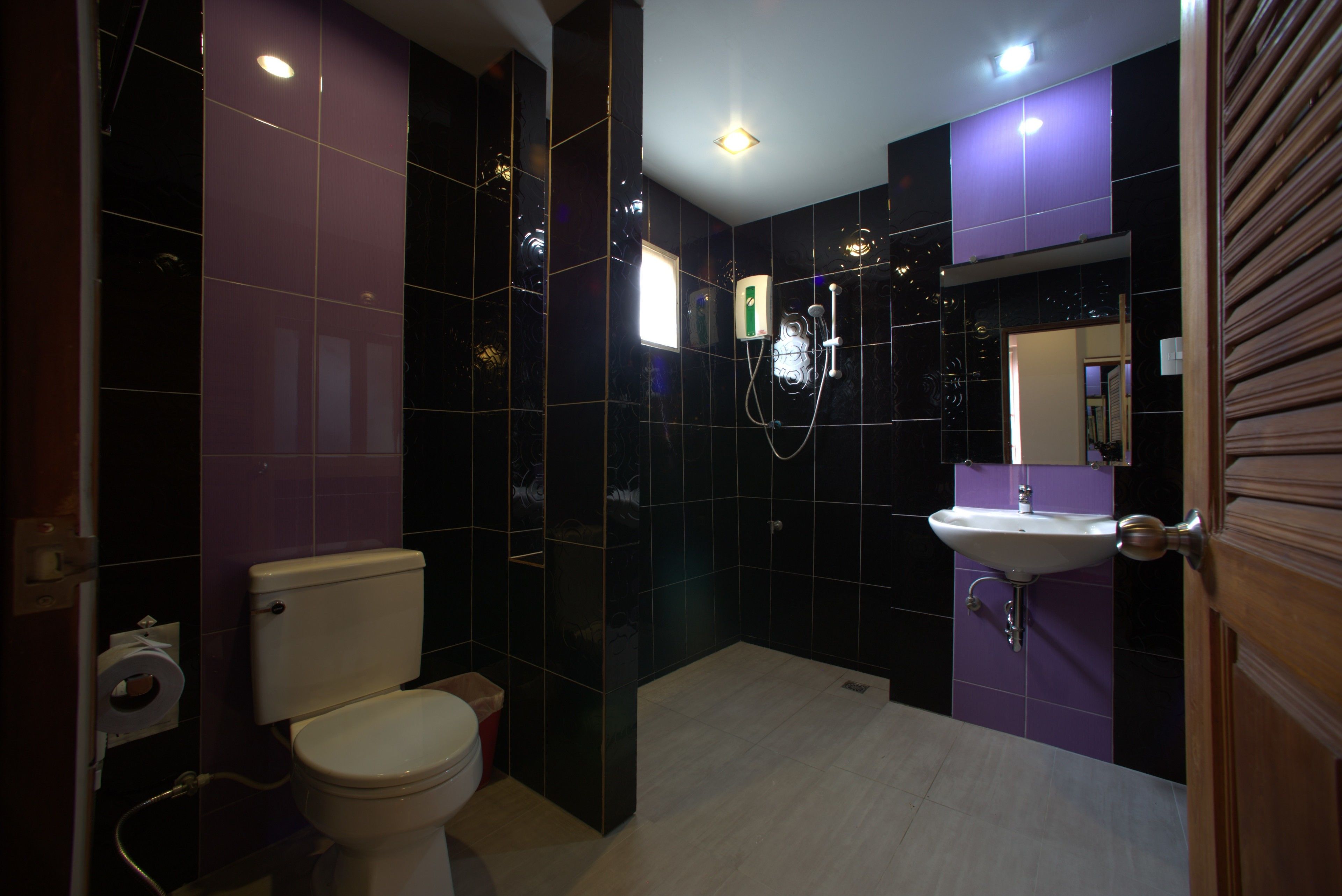 A modern bathroom with a toilet, sink, and shower.