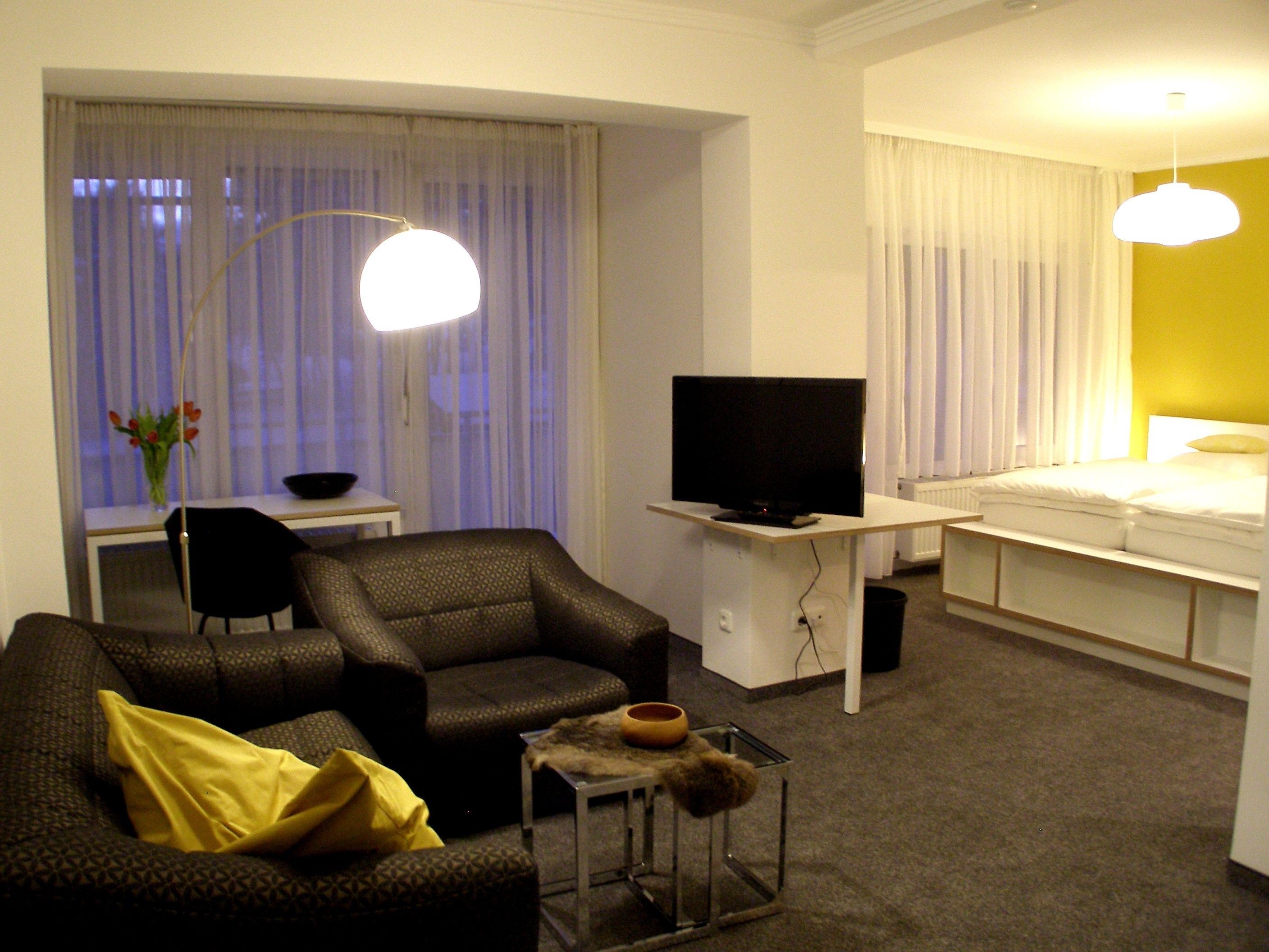 junior suite, balcony, garden view | living area | lcd tv