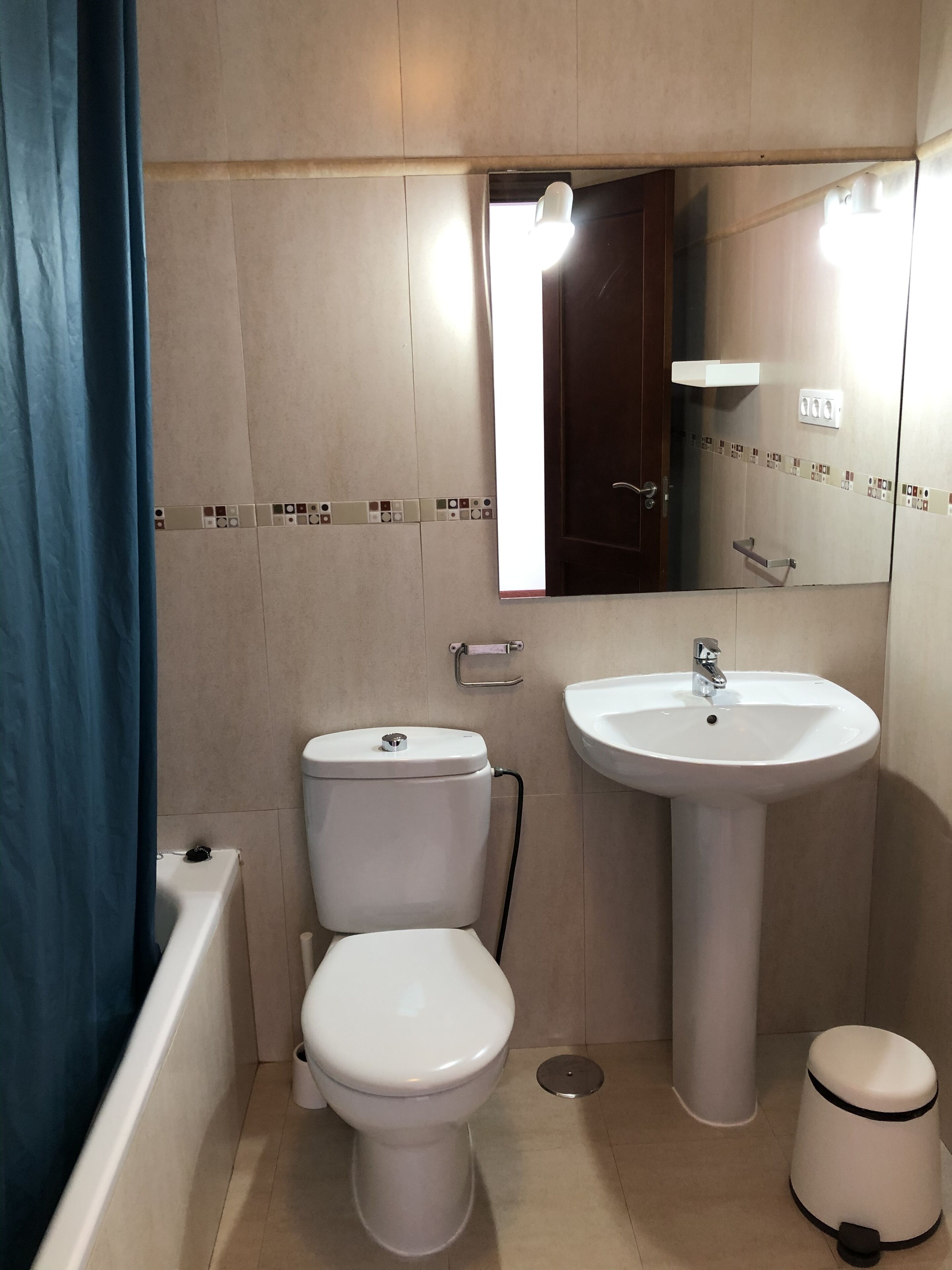 A bathroom with a toilet, sink, and bathtub.