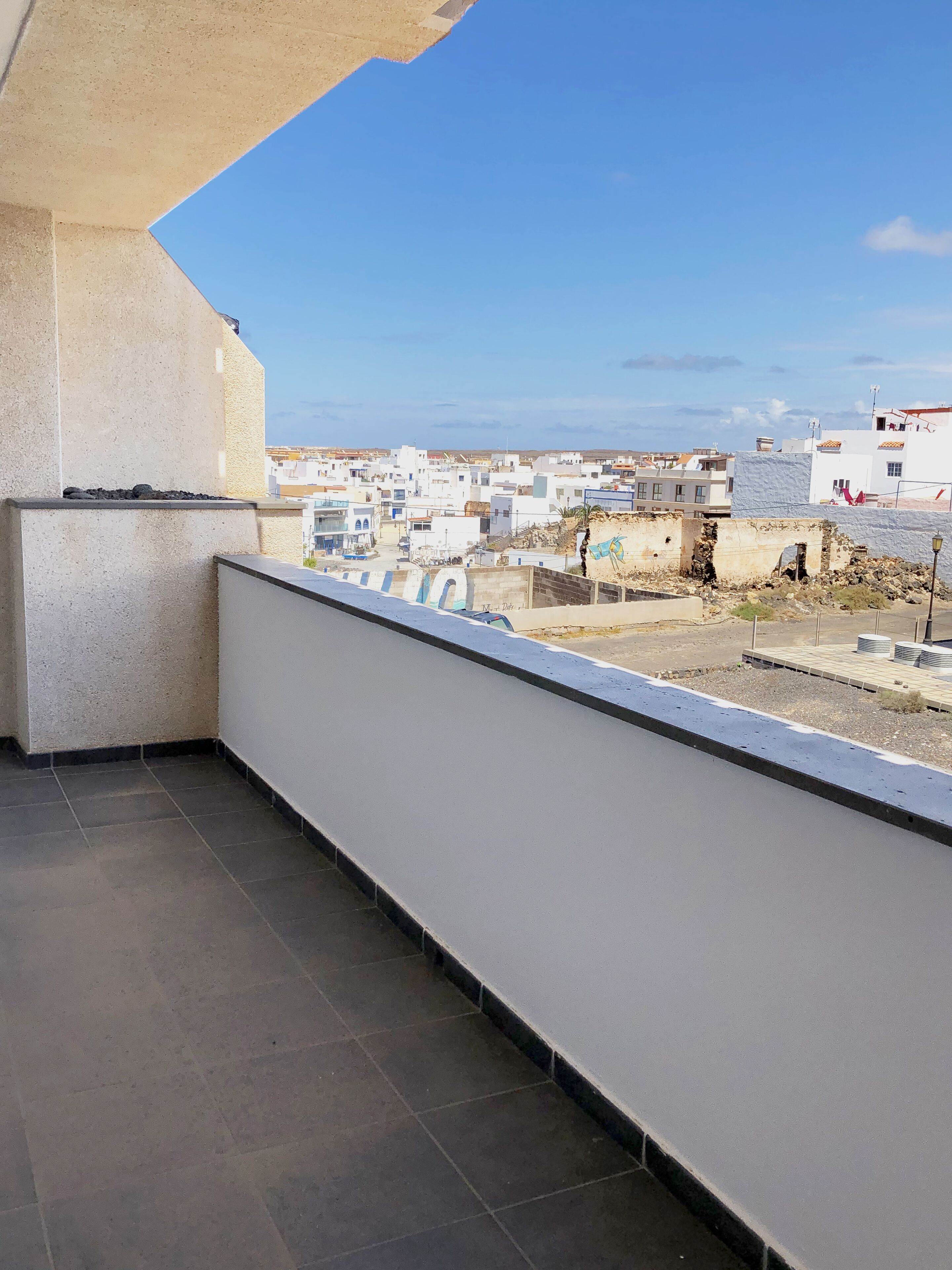 Une terrasse sur le toit offrant une vue sur un quartier résidentiel.