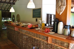 A breakfast bar with wicker baskets, a chalkboard menu, and various breakfast items.