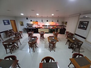 Enjoy meals in a casual setting with a communal dining space featuring a kitchen and comfortable seating.