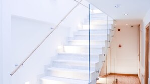 A modern staircase with glass railings leading to a landing. - Hotel Old Sarajevo (Sarajevo)