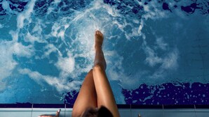 A person floating in a pool with clear water and visible bubbles. - Hotel France (Vinnytsia)