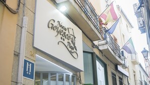 A building with a sign for 'Hostal Goyescas Plaza'.