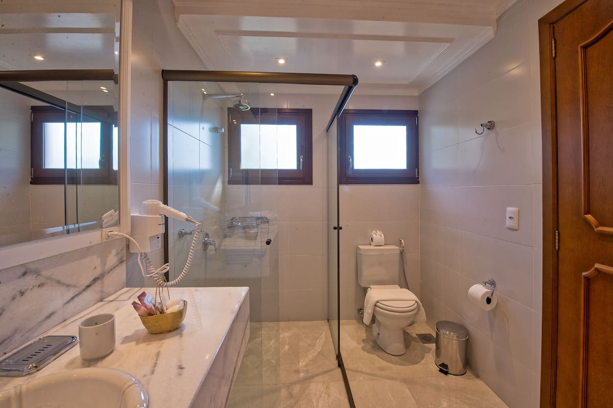 luxury suite, jetted tub | bathroom | designer toiletries, hair dryer, bathrobes, slippers