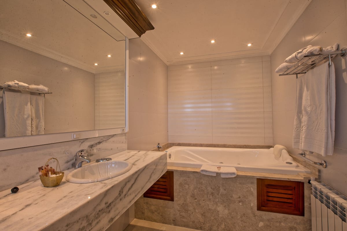 luxury suite, jetted tub | bathroom | designer toiletries, hair dryer, bathrobes, slippers