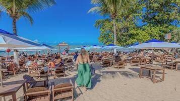 On the beach, white sand, sun-loungers, beach umbrellas